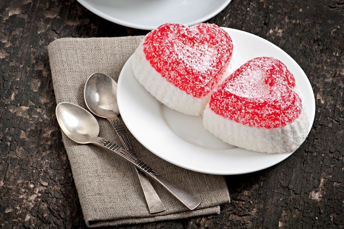 A beautifully decorated heart cake with pink frosting