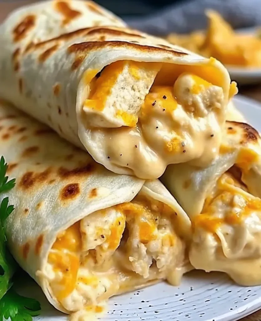 Crispy cheesy chicken garlic wraps sliced and garnished with fresh parsley, ready to serve