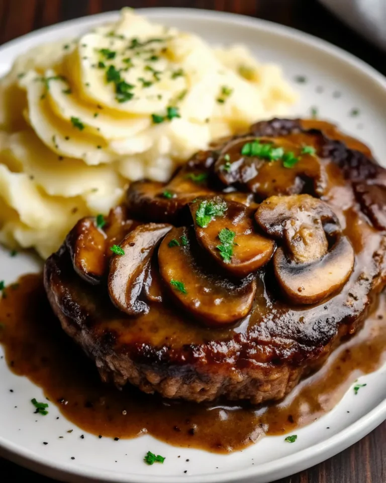 Grilled steak with savory mushroom sauce is a comforting, protein-packed meal with creamy mashed potatoes. A must-try dinner classic!