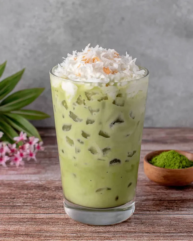 Overhead view of neatly arranged Matcha Coconut Cloud ingredients including matcha powder, coconut milk, sparkling water, coconut cream, condensed milk, vanilla extract, and honey on a light background.