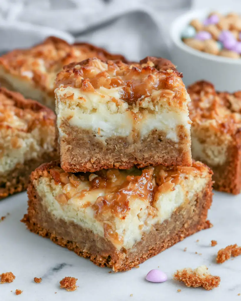 Close-up of homemade Crème Brûlée Cookie Bars topped with crunchy toffee bits, featuring a soft chewy center and golden caramelized topping on a white plate in natural kitchen lighting.