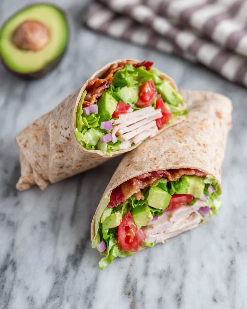 Discover the best California Turkey Club Wraps recipe made with juicy turkey, crispy bacon, creamy avocado, fresh lettuce, and tomatoes wrapped in a soft tortilla. This easy 20-minute lunch is perfect for busy weekdays, meal prep, picnics, or a light family dinner.