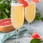 A refreshing Grapefruit Prosecco Cocktail served in a chilled Champagne flute and garnished with a fresh grapefruit wedge. This easy sparkling cocktail combines Prosecco, fresh grapefruit juice, and Cointreau for the perfect brunch or summer party drink.
