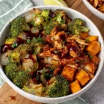 Make these Roasted BBQ Chicken and Sweet Potato Bowls for an easy one-pan dinner packed with juicy BBQ chicken, roasted sweet potatoes, broccoli, and onions. This healthy recipe is perfect for busy weeknights, meal prep, and family dinners. Ready in under an hour, it's loaded with smoky, sweet, and savory flavors everyone will love.