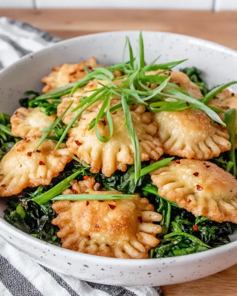 One Pan Greens and Dumplings makes a quick, comforting dinner with golden dumplings, tender greens, ginger, and chili crisp