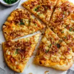 5 Ingredient Pumpkin and Gouda Pizza topped with creamy pumpkin puree, melted Gouda cheese, caramelized onions, garlic, and fresh parsley on a crisp homemade pizza crust.